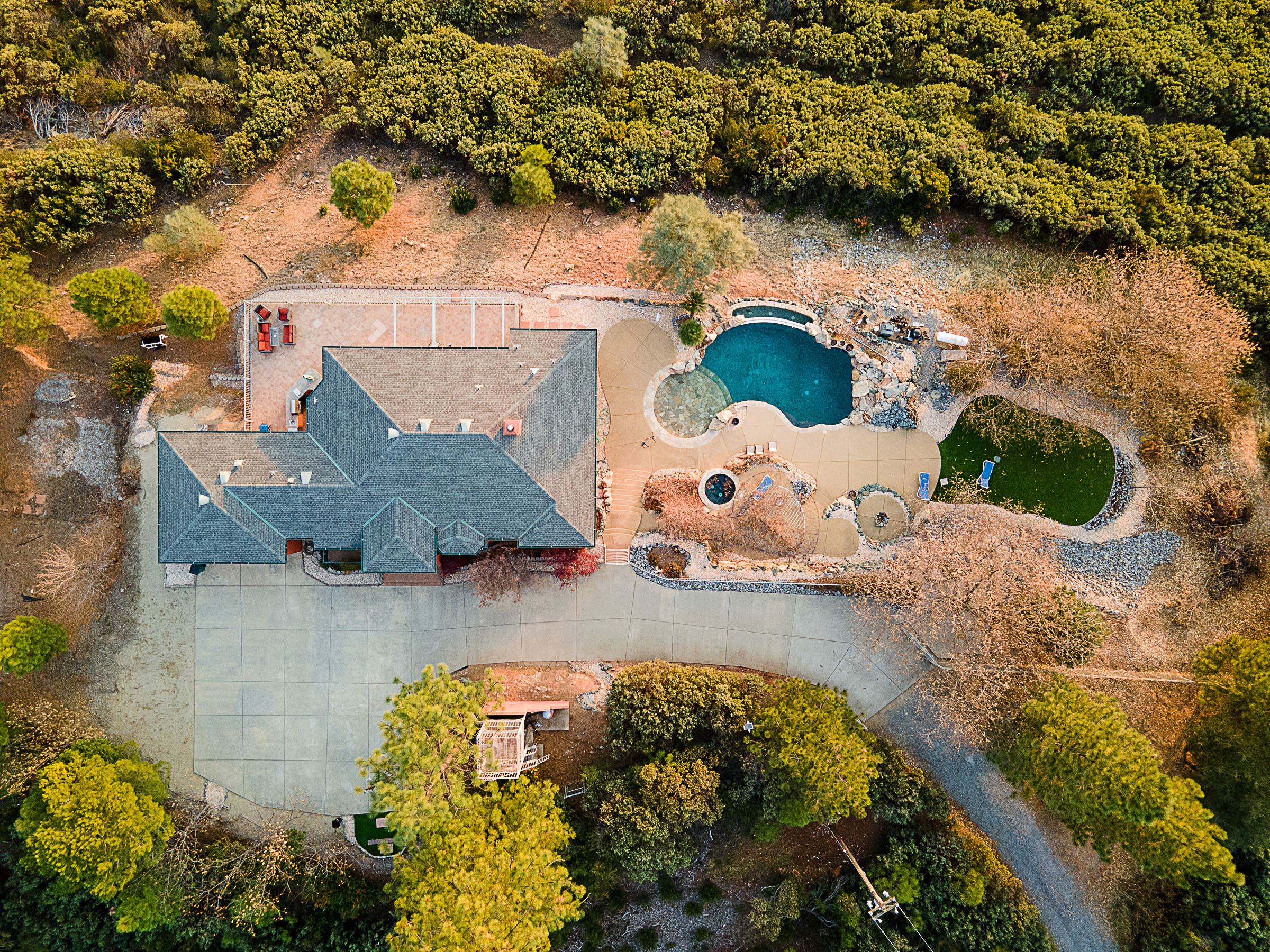 Overhead view of the residence, pool, terraces and surrounding land