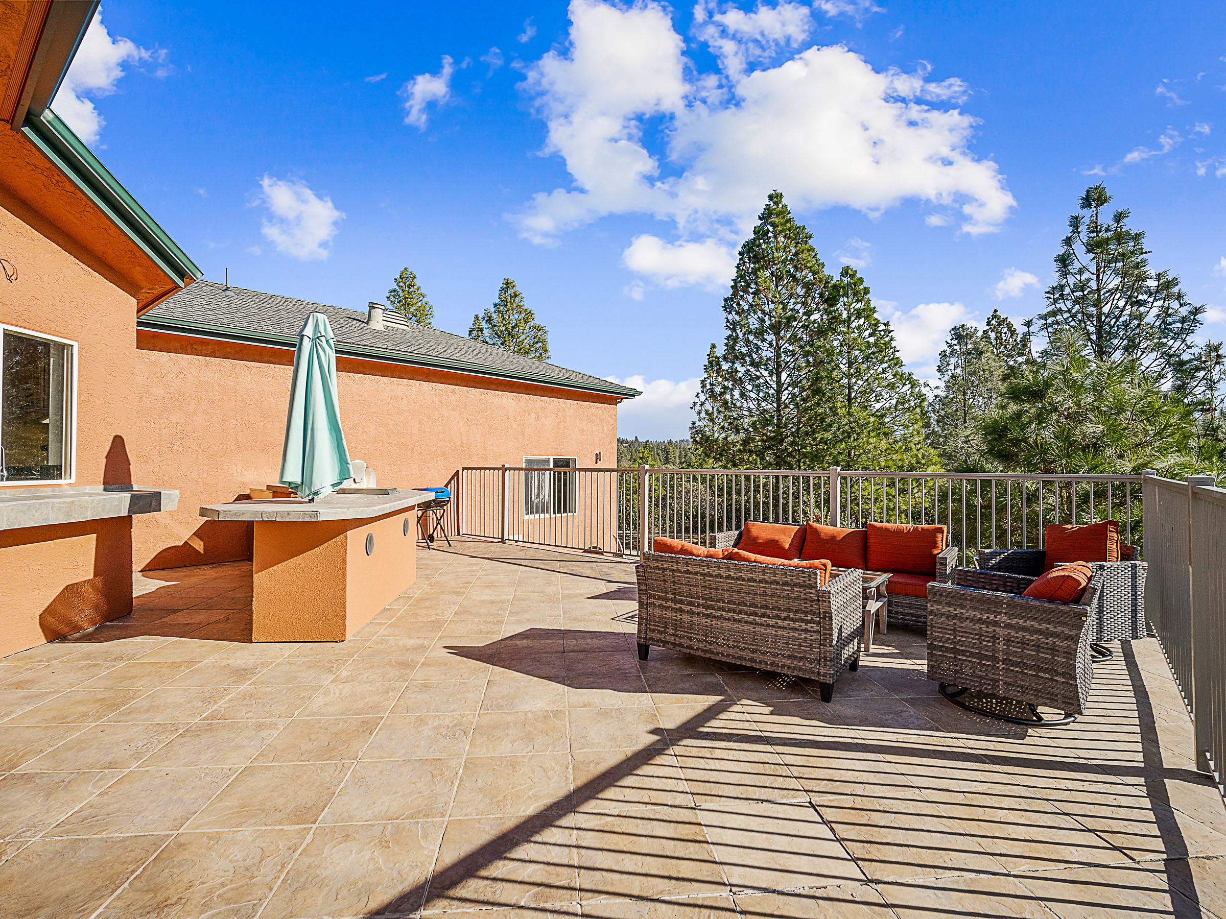 Main-floor deck with outdoor kitchen and lounge seating