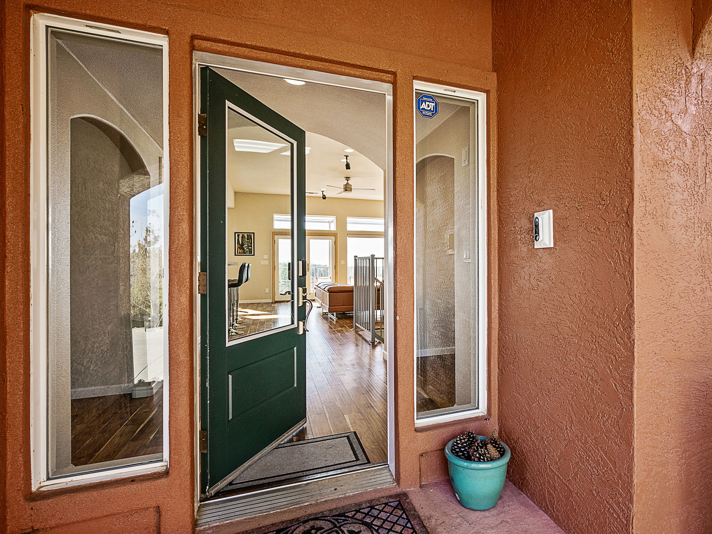 Front entry opening toward the bright interior and canyon-facing windows